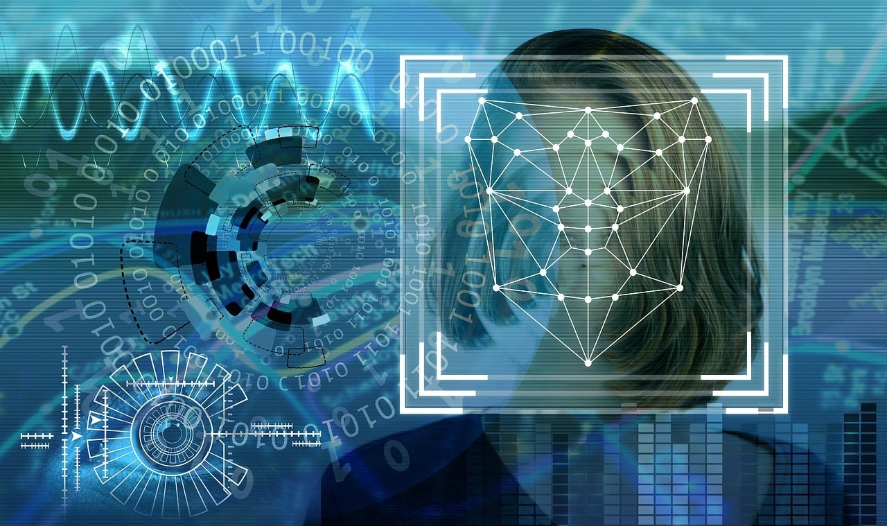 Digitale Passbilder Auf blauem Hintergrund finden sich kreisförmig angeordnete Nuller und Einsen, grafische Symbole, Kurven und Diagramme und auf der rechten Seite drei konzentrische Quadrate mit Punkten und Verbindungslinien vor einem Gesicht.