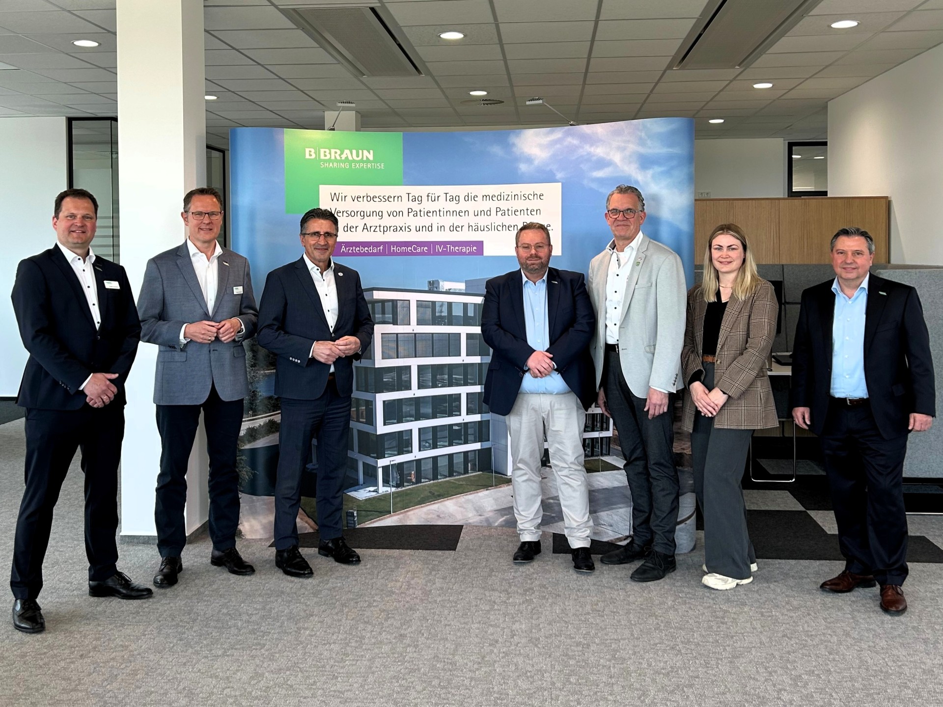 Wirtschaftsförderin Kim Lachmann steht mit dem Mülheim-Kärlicher Stadtbürgermeister Gerd Harner, Investor Ilmi Viqa und Vertretern der Firm B. Braun im Foyer des Unternehmens.