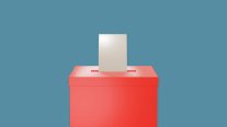 Wahlurne Die Wahlurne ist rot, in die Wahlurne wird gerade ein Zettel hinein gesteckt.
